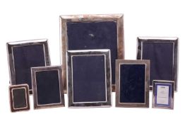 A collection of seven silver photograph frames, the largest 36cm x 31cm and the smallest 10.5cm x 8c