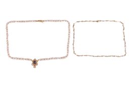 Two keshi pearl necklaces; the first comprising an openwork scrolled drop pendant centred with a sap