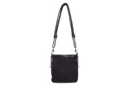 Gucci - a crossbody bag in black monogrammed canvas with leather trim, top zip closure, equipped wit