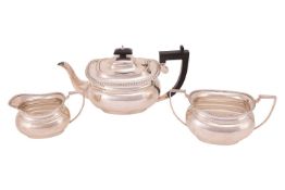 A three-piece silver tea set, comprising a teapot, milk jug and two-handled sugar basin, of oval for