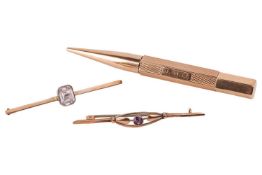 A 9ct yellow gold propelling pencil with an engine-turned hexagonal barrel, an octagonal-cut paste c