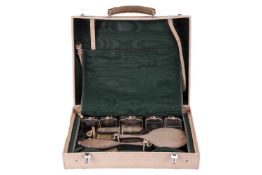 A silver dressing table set in a fitted travelling case; all with engine-turned decoration comprisin