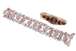 An Indian bracelet and a tiger's eye bangle; the bangle featuring five tiger's eye cabochons in grad