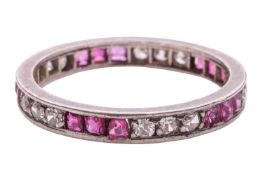 A diamond and ruby eternity ring, composed of alternating segments of synthetic rubies and single-cu