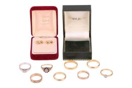 Eight rings and a pair of earrings; to include a single stone diamond ring, the princess cut diamond