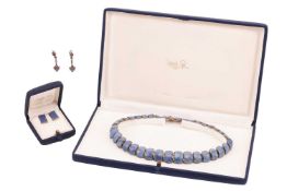 A boxed lapis lazuli necklace and earrings suite, set with graduated polished lapis lazuli panels in