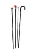 Y A GROUP OF FOUR BLACK AND SILVER METAL MOUNTED WALKING STICKS