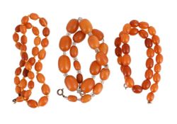 THREE AMBER COLOURED NECKLACES