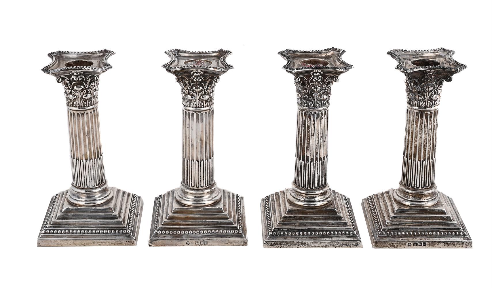 A SET OF FOUR EDWARDIAN SILVER SHORT CORINTHIAN COLUMN CANDLESTICKS