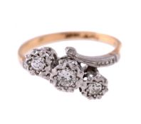 A DIAMOND THREE STONE CROSSOVER RING, CIRCA 1950