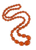 AN AMBER COLOURED BEAD NECKLACE