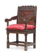 AN OAK WAINSCOT ARMCHAIR, 18TH CENTURY
