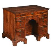 A GEORGE I WALNUT AND FEATHERBANDED KNEEHOLE DESK, CIRCA 1720