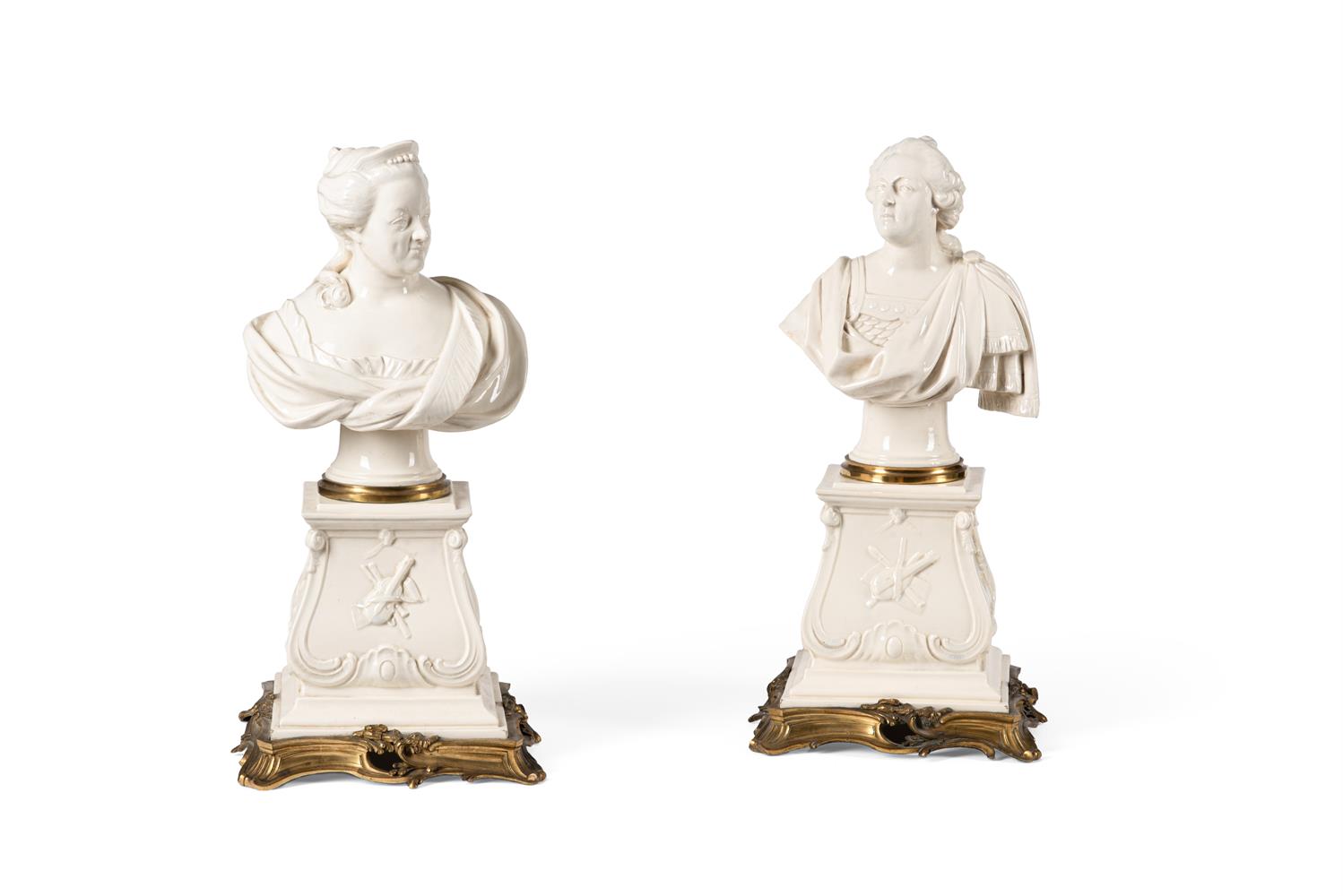 A COMPANION PAIR OF FRENCH CREAMWARE AND GILT-METAL MOUNTED BUSTS, CIRCA 1910