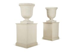 A PAIR OF WHITE PAINTED COMPOSITION STONE RIBBED URNS OF LARGE SIZE, MODERN