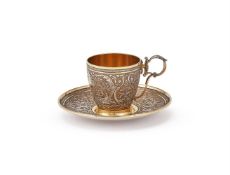 A CASED CONTINENTAL SILVER GILT CUP AND SAUCER