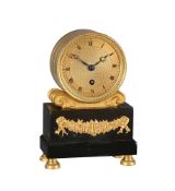 AN ORMOLU AND BLACK MARBLE SMALL MANTEL TIMEPIECE IN THE MANNER OF BAETENS