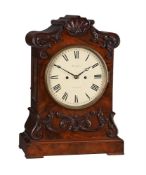 A VICTORIAN CARVED MAHOGANY BRACKET CLOCK
