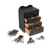 A SMALL DRAWER CABINET CONTAINING A COLLECTION OF LONGCASE CLOCK HANDS