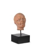 A GREEK TERRACOTTA HEAD OF A FROWNING MAN, SMYRNA, C. 1ST CENTURY BC.