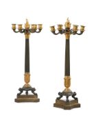 A PAIR OF FRENCH EMPIRE PATINATED AND GILT BRONZE CANDELABRA, AFTER THE ANTIQUE, EARLY 19TH CENTURY