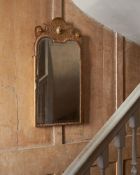 A GEORGE I CARVED GILTWOOD AND GESSO WALL MIRROR, IN THE MANNER OF BELCHIER, CIRCA 1720