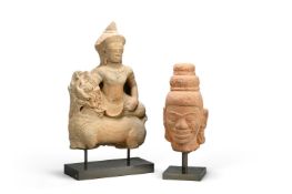 A Khmer grey sandstone figure of a deity riding on a lion