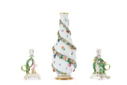 A PAIR OF MEISSEN FLOWER-ENCRUSTED FIGURAL CHAMBER CANDLESTICKS, LATE 19TH CENTURY
