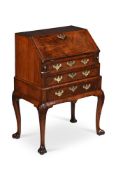 A FINE GEORGE II BURR WALNUT, WALNUT AND FEATHERBANDED BUREAU ON STAND, CIRCA 1730
