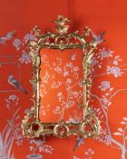 A CARVED GILTWOOD MIRROR, IN GEORGE III STYLE, FIRST HALF 19TH CENTURY