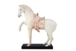 ‡ A CHINESE PAINTED POTTERY FIGURE OF A PRANCING HORSE, TANG DYNASTY (AD 618-907)