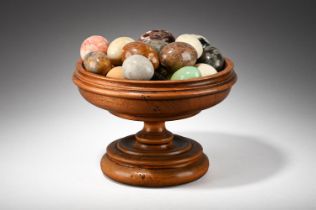 A COLLECTION OF APPROXIMATELY TWENTY THREE CARVED STONE MODELS OF EGGS, OF RECENT MANUFACTURE