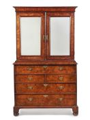 A GEORGE I FIGURED WALNUT AND FEATHERBANDED SECRETAIRE CABINET, CIRCA 1720