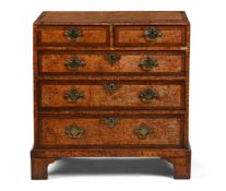 A GEORGE II BURR ELM AND CROSSBANDED CHEST OF DRAWERS, CIRCA 1740