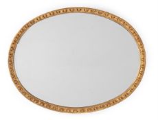 A LARGE CARVED GILTWOOD OVAL MIRROR, IN GEORGE III STYLE, 19TH CENTURY
