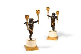 A PAIR OF FRENCH GILT AND PATINATED BRONZE CHERUB TWIN LIGHT CANDELABRA, CIRCA 1780-1820