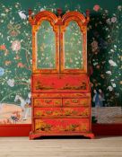 A SCARLET LACQUER AND GILT CHINOISERIE DECORATED BUREAU CABINET