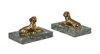 A PAIR OF GILT BRONZE RECUMBENT HOUNDS, LATE 19TH CENTURY