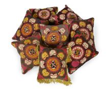 A SET OF EIGHT SUZANI CUSHIONS, 20TH CENTURY USING EARLIER ELEMENTS