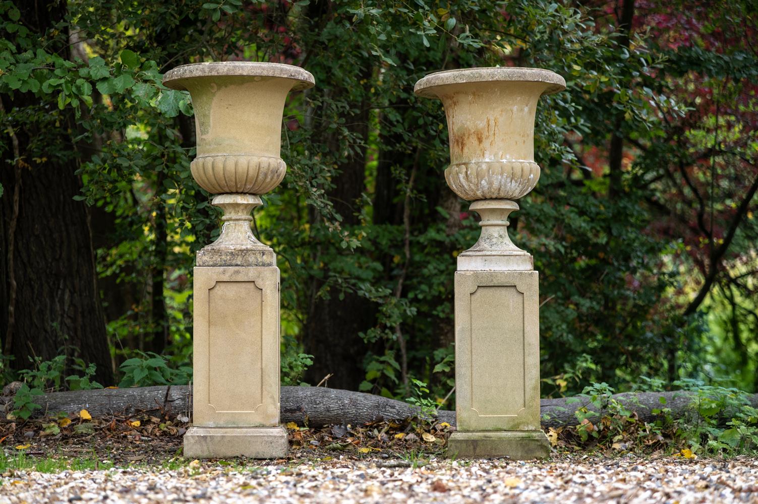 A PAIR OF COMPOSITION STONE URNS LATE 20TH CENTURY Set on pedestals ...