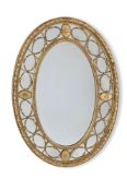 A LARGE CARVED GILTWOOD AND GESSO OVAL MIRROR, IN GEORGE III STYLE, FIRST HALF 19TH CENTURY