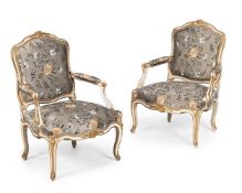 A PAIR OF LOUIS XV CREAM PAINTED AND PARCEL GILT ARMCHAIRS, CIRCA 1760