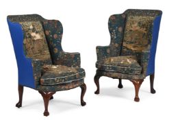 A RARE PAIR OF GEORGE I WALNUT AND NEEDLEWORK UPHOLSTERED WING ARMCHAIRS, CIRCA 1725