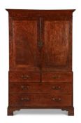 A GEORGE III MAHOGANY AND 'PLUM PUDDING' MAHOGANY CLOTHES PRESS, CIRCA 1800