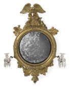 A GEORGE IV CARVED GILTWOOD CONVEX MIRROR, IN THE MANNER OF THOMAS FENTHAM, CIRCA 1825