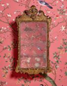 A GEORGE II CARVED GILTWOOD AND GESSO MIRROR, CIRCA 1730