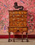 A QUEEN ANNE FIGURED ELM AND FRUITWOOD CROSSBANDED CHEST ON STAND, CIRCA 1710