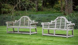TWO SIMILAR HARDWOOD GARDEN BENCHES, AFTER THE DESIGN BY SIR EDWARD LUTYENS, CONTEMPORARY