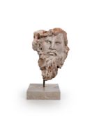 A CARVED STONE BEARDED MASK, LATE 20TH CENTURY