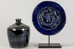 two pieces of Chinese blue glazed earthenware : a pitcher and a disc with dragon decor